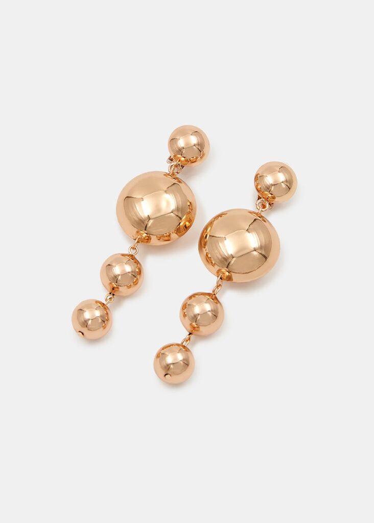 Polished gold-tone pair of earrings are strung with dangling round pendants that will gently sway and catch the light.
