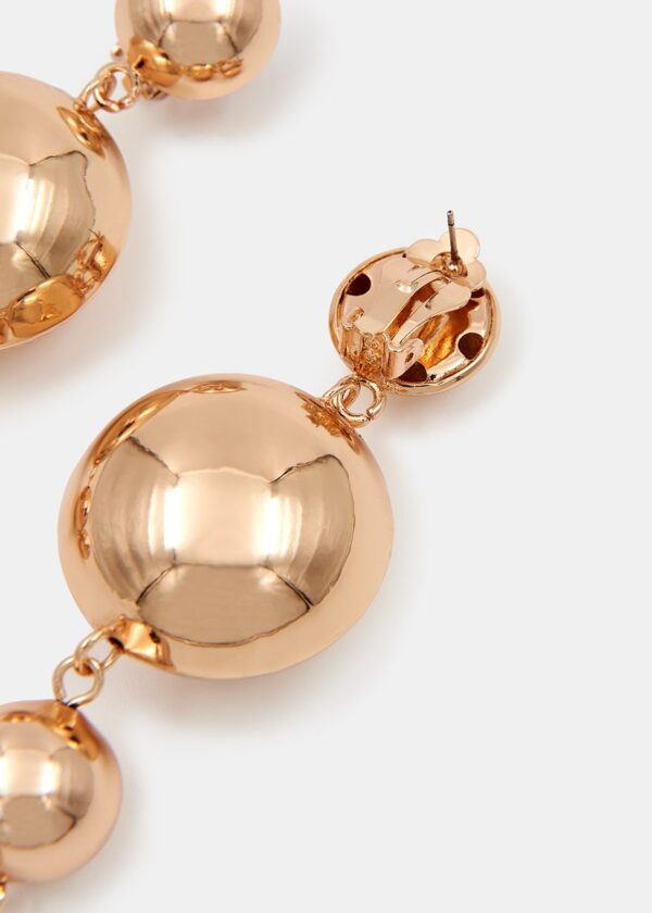 Polished gold-tone pair of earrings are strung with dangling round pendants that will gently sway and catch the light.